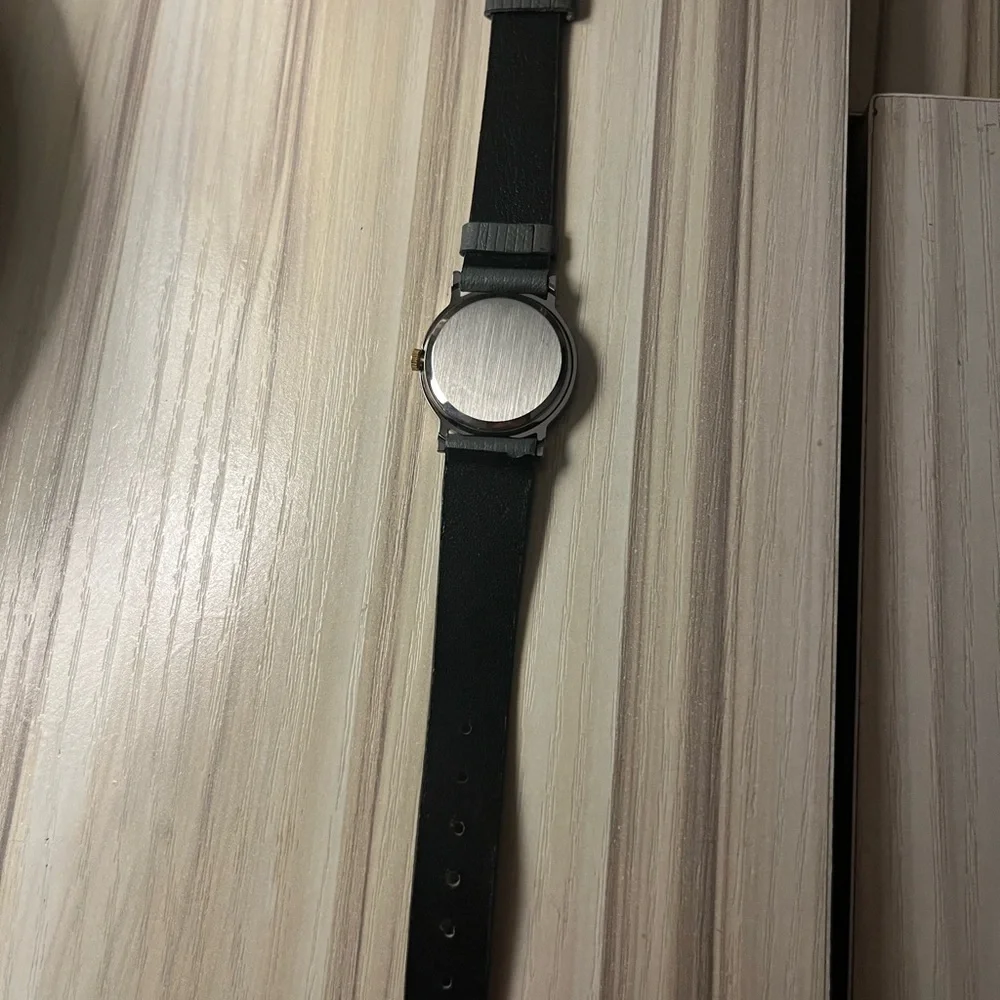 Gucci branded watch with grey leather strap and gold details